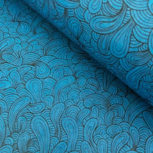 May include: Blue fabric with a black and white swirling pattern. The fabric has a textured surface.