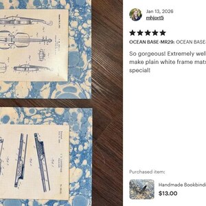 May include: Two rectangular frame mats featuring a blue and white marbled pattern. Each mat contains a centered off-white paper insert displaying black technical patent illustrations. The top insert shows a violin, and the bottom shows a flute.