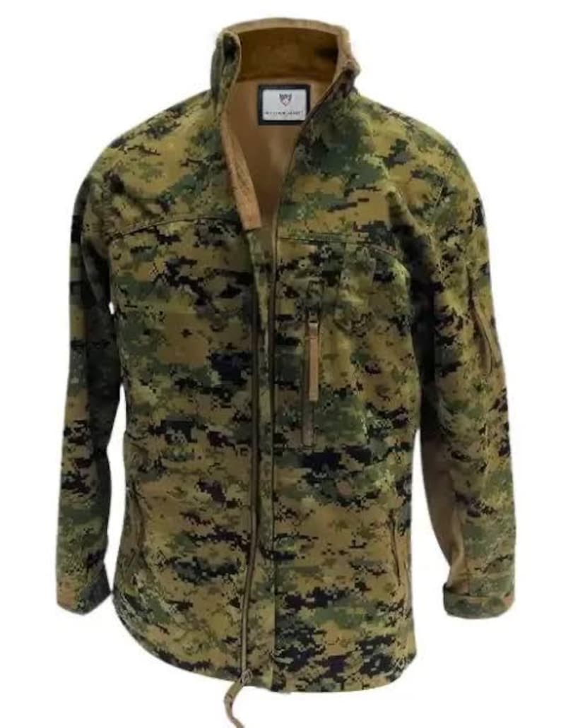 May include: A camouflage jacket in shades of green, brown, and black. The jacket has a full-length zipper, a high collar, and multiple pockets. The jacket has a tag on the chest. The jacket is made of a durable material.