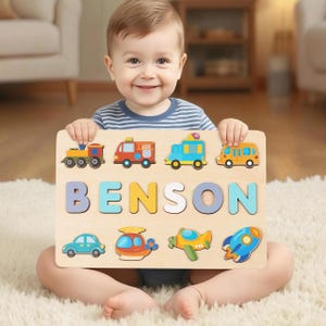 May include: Wooden puzzle featuring colorful transportation vehicles and the name "BENSON" in large, multi-colored letters. The puzzle includes a train, fire truck, ambulance, school bus, car, helicopter, airplane, and rocket ship.