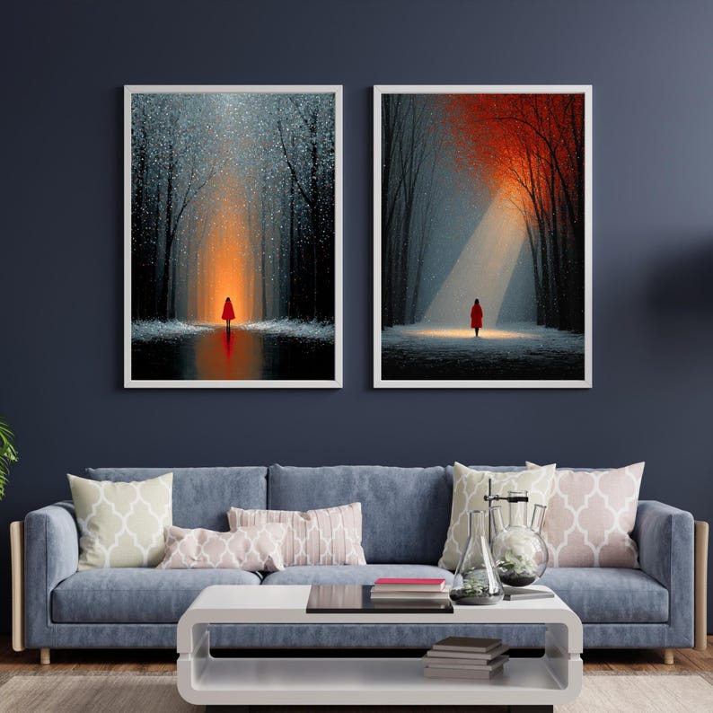 May include: Two framed art prints depict a person in a red coat in a forest. One shows a person standing in a glowing orange light, the other in a white spotlight. The artwork features a dark forest with snow and a reflective surface.