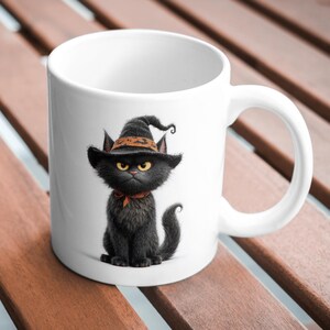 May include: A white ceramic mug featuring a graphic illustration of a fluffy black cat wearing a pointed black witch hat with an orange band and a matching orange neck scarf. The cat has large yellow eyes and a stern, focused facial expression.