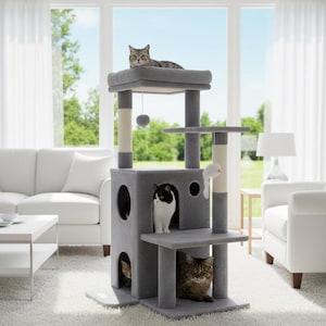 May include: A gray cat tree with multiple levels, platforms, and scratching posts. Several cats are resting on the structure, which includes a top perch, a hanging toy, and a built-in hideaway. The cat tree is in a living room setting.