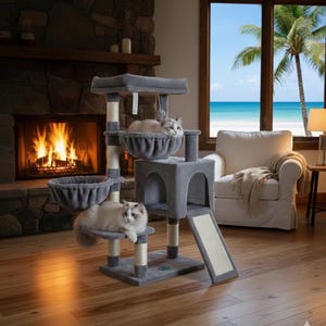 May include: A gray cat tree with multiple levels, including platforms, baskets, and a ramp. Two cats are resting on the tree. The cat tree has a neutral color scheme and is designed for indoor use. The background includes a fireplace and a window with a beach view.