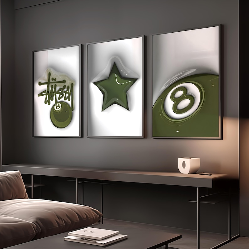 May include: Three framed wall art pieces. The left frame features the word "Stussy" in green with an 8-ball graphic. The center frame has a green star. The right frame shows a green 8-ball. All are on a white background.
