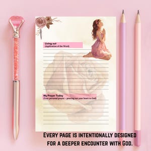 May include: A pink and silver pen, a lined journal with a floral illustration, and two pencils. The journal has text that reads "Living out" and "My Prayer Today". The bottom of the journal reads "EVERY PAGE IS INTENTIONALLY DESIGNED FOR A DEEPER ENCOUNTER WITH GOD."