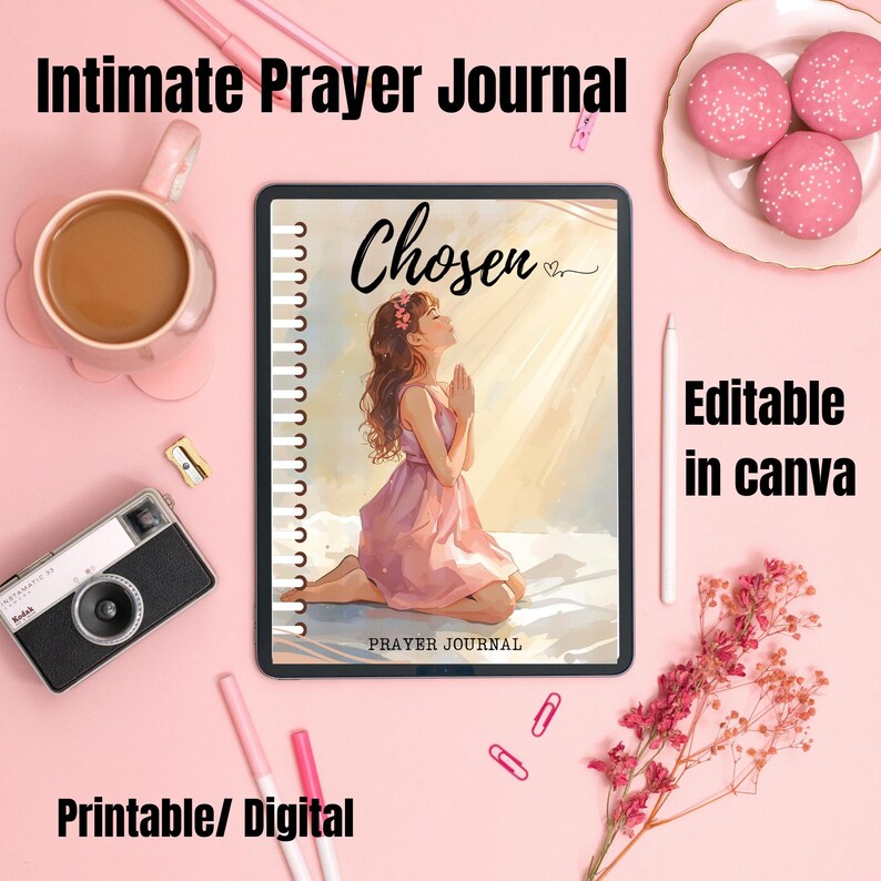 May include: A pink-themed flat lay featuring a prayer journal with the word "Chosen" on the cover, a drawing of a woman praying, and the text "Prayer Journal". The image also includes a cup of coffee, a camera, pens, and macarons.