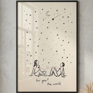 May include: Black framed art print featuring a line drawing of two figures lying down, gazing at a starry sky with a crescent moon and shooting star. The text "for you? the world." is below the figures. The artwork is displayed on a neutral wall.