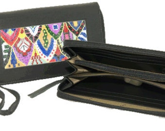 May include: A black leather wallet with a zipper closure and a colorful beaded design in a window on the front. The wallet is open to show the interior lining and multiple compartments.