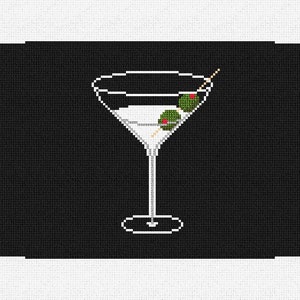 Op de afbeelding: Een wit martini-glas met twee groene olijven aan een cocktailprikker, op een zwarte achtergrond.