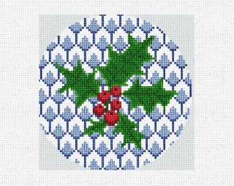 May include: A white background with a blue and white geometric pattern. A green holly sprig with red berries is centered on the pattern.