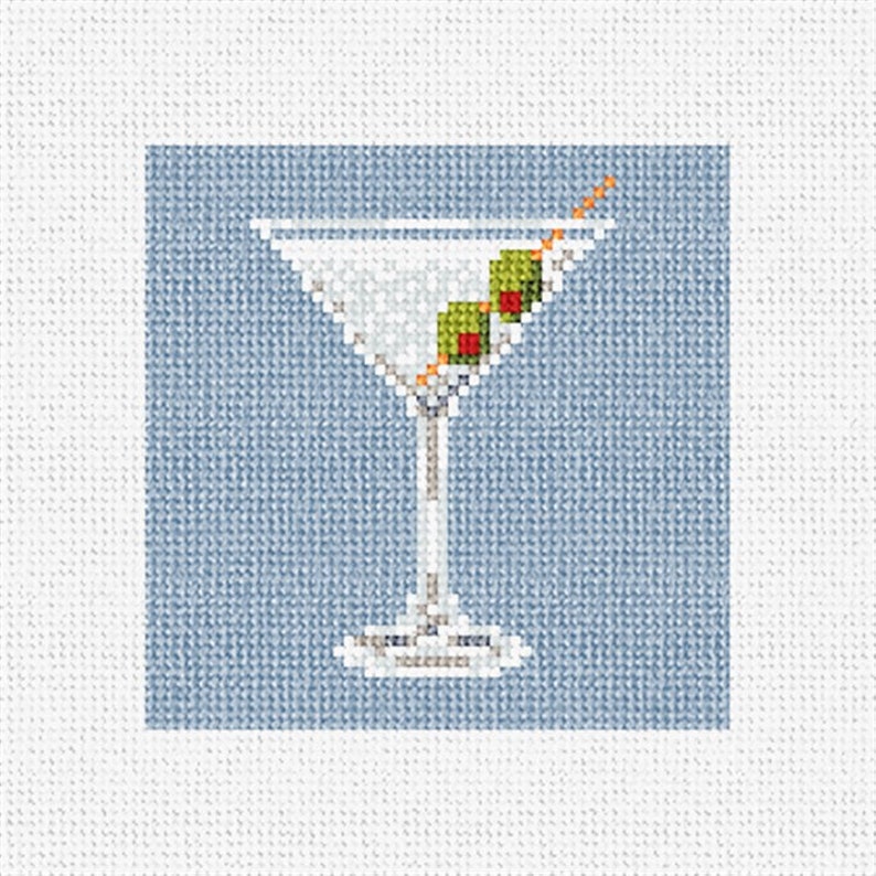 May include: A white martini glass with two green olives and a toothpick on a light blue background.