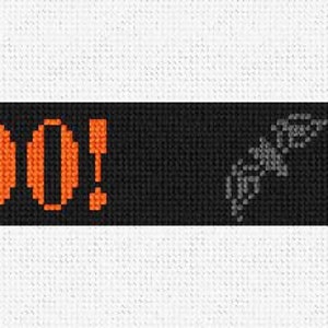 May include: A black banner with the word "BOO!" in orange letters and a black silhouette of a spider hanging from a web on the right side.