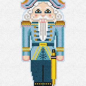 May include: A blue and white nutcracker with a gold hat and a yellow sash. The nutcracker has a white beard and mustache and is wearing a blue and white uniform.