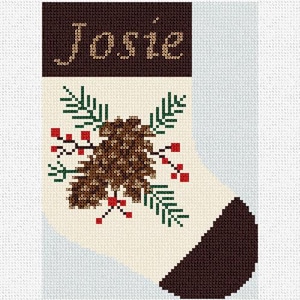 Könnte beinhalten: Ein Weihnachtsstrumpf mit dem Namen "Josie", der mit beigefarbenem Faden auf einem dunkelbraunen Oberteil gestickt ist. Der Strumpf hat einen cremefarbenen Körper mit einer braunen Ferse und Spitze. Auf der Vorderseite sind ein Tannenzapfen und rote Beeren gestickt.
