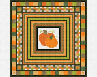 May include: A cross-stitch pattern featuring two orange pumpkins with green stems and leaves, surrounded by a multi-colored frame with orange, green, brown, and white squares.