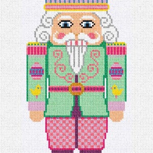 May include: A cross-stitch design of a nutcracker soldier. The figure is dressed in a green jacket with pink accents, pink pants, and a colorful hat. The design includes a white mustache and curly hair, and a gold belt.