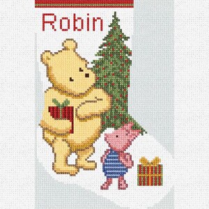 May include: A cross-stitch Christmas stocking featuring Winnie the Pooh, Piglet, and a Christmas tree. The word "Robin" is stitched in red above the characters. Winnie the Pooh holds a red gift, and Piglet stands nearby. A wrapped gift is also present.
