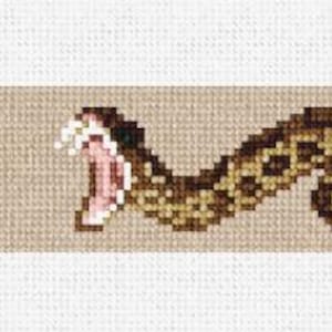 May include: A brown and black snake with its mouth open, showing its fangs. The snake is coiled in a S-shape on a beige background.