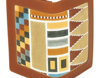 May include: A brown leather wallet with a geometric pattern in shades of blue, yellow, brown, and white. The pattern is stitched into the fabric and is visible through a clear window on the front of the wallet.