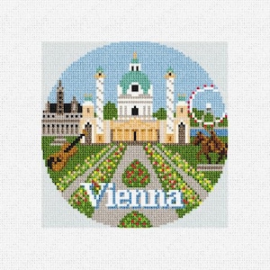 May include: A circular cross-stitch design featuring a colorful depiction of Vienna, Austria. The design includes a building with a dome, a Ferris wheel, and a horse-drawn carriage. The text "Vienna" is written in a stylized font at the bottom of the design.