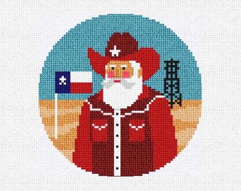 May include: A round, cross-stitch design featuring Santa Claus in a cowboy hat and red jacket. He stands in front of a Texas flag and a blue background. An oil derrick is on the right side of the image.