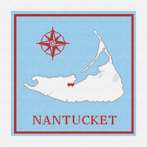 May include: A blue and red cross-stitch design of the island of Nantucket, Massachusetts. The island is outlined in white with a red heart in the center. A red compass rose is in the upper left corner. The words "NANTUCKET" are in red at the bottom of the design.