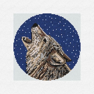 May include: A cross-stitch design featuring a howling wolf. The wolf is rendered in shades of brown and gray, set against a dark blue background with white star accents. The design is circular, with a light blue border.