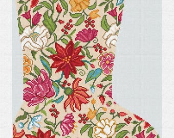 May include: A Christmas stocking with a floral design. The stocking is beige with a pattern of red, pink, yellow, and white flowers, green leaves, and red berries. The name "Loretta" is embroidered at the top.