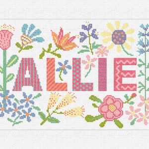 May include: A colorful cross-stitch design featuring the name "ALlie" surrounded by flowers and leaves. The letters are made up of different patterns and colors.