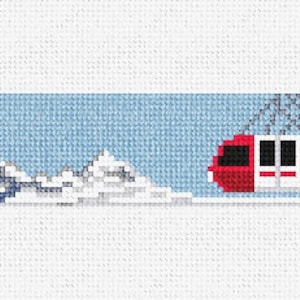Puede incluir: Un teleférico rojo con ventanas está suspendido por cables sobre un fondo de cielo azul. El teleférico está frente a una cordillera nevada.