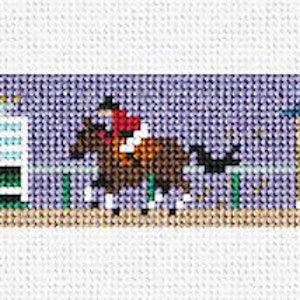 May include: A cross-stitch pattern of a horse and rider jumping over a fence, with a white building in the background. The scene is set against a purple sky with white stars.