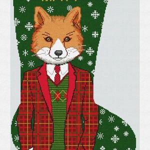May include: A Christmas stocking featuring a fox wearing a red plaid suit and green sweater. The stocking is green with white snowflakes and the name "MATT" in gold letters.