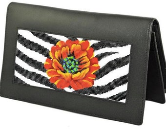 May include: Black leather clutch with a zebra print and a red flower embroidered on the front.