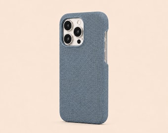 May include: A blue phone case with a textured fabric finish. The case has a camera cutout and button access. The phone case is designed to protect the phone from scratches and damage. The case is a solid color and has a minimalist design.
