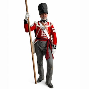 May include: A person in a historical military uniform. The red jacket has white accents and a white sash. The gray trousers and black boots complete the ensemble. The person is holding a wooden staff and wearing a tall black hat.