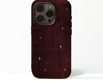 May include: A deep burgundy smartphone case featuring a subtle, textured finish and a scattered pattern of small, four-pointed gold stars. The case includes a precise cutout for the rear camera module, which contains three circular lenses and a flash.