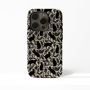 May include: A phone case with a repeating pattern of black cat silhouettes and floral elements on a cream background. The case has a camera cutout and black side buttons.
