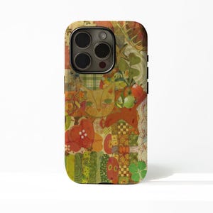 May include: A smartphone case featuring a collage design with a central yellow cat face, red heart shapes, green clover leaves, and various checkered and floral patterns in shades of orange, yellow, green, and red with white lace accents.
