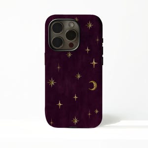 May include: A dark purple smartphone case featuring a pattern of gold-coloured stars and a crescent moon. The case has a cutout for a triple-lens camera system on the upper left side and covers the back and sides of the mobile device.