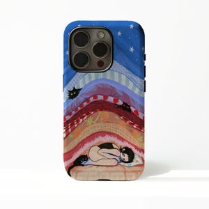 May include: A smartphone case featuring a colourful illustration of a person curled up under layers of patterned blankets. The design includes small black cats peeking out from between the fabric layers, white stars on a blue background, and a cosy scene.