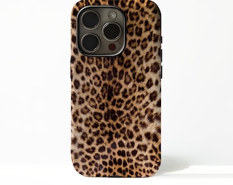 May include: A smartphone case with a leopard print design. The case features a pattern of brown and black spots on a tan background. The camera lenses and buttons are visible on the case.