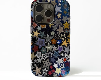 May include: A smartphone case covered in a collage of various star shapes in multiple colors, including yellow, blue, red, and white. The case has a dark blue background and a camera cutout.