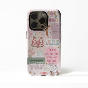 May include: A light pink phone case with a floral and religious design. The case features the words "BE THE light" and "JESUS" in a script font, along with other inspirational quotes and a rainbow graphic.