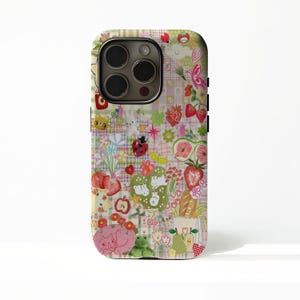 May include: A smartphone case featuring a multi-colored collage pattern on a light green and white checkered background. The design includes various illustrations such as strawberries, a ladybug, a frog, a cat, a rabbit, flowers, and fruit.