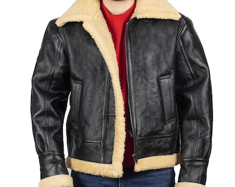 May include: Black leather jacket with a tan shearling collar and lining. The jacket has a zip-up front, two front pockets, and a classic aviator style. The model is wearing a red turtleneck and blue jeans.