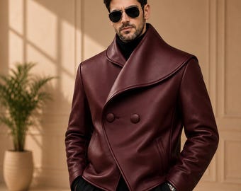 May include: A deep burgundy leather jacket featuring a wide, oversized shawl collar, a double-breasted front closure with two large matching buttons, long sleeves, and a smooth finish. The jacket is worn over a black turtleneck sweater.