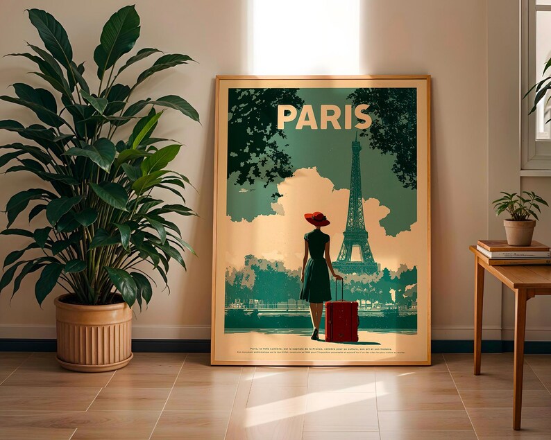 May include: A framed travel poster with the word "PARIS" at the top. The poster depicts a woman in a dress and red hat, pulling a red suitcase, with the Eiffel Tower in the background. The poster has a vintage travel theme.