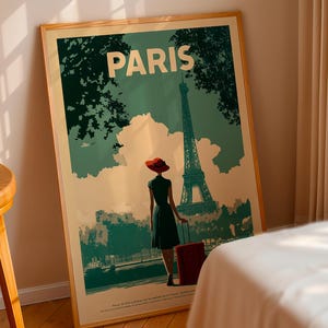 May include: A framed travel poster with the word "PARIS" at the top. The poster depicts a woman in a red hat and dress, with a suitcase, walking towards the Eiffel Tower. The poster has a vintage travel theme.
