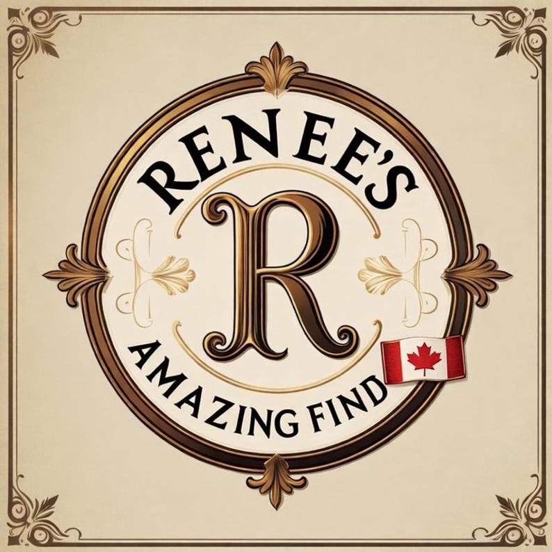 May include: A circular logo with the text "RENEE'S AMAZING FIND" in a decorative font. The letter "R" is prominently displayed in the center. A small Canadian flag is on the right side of the logo. The logo has a gold and brown color scheme.